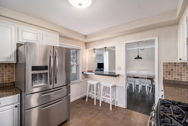 3018 Guilford Dr, Royal Oak, MI 48073 - kitchen with stainless steel appliances, tile countertops, white cabinetry, and decorative backsplash