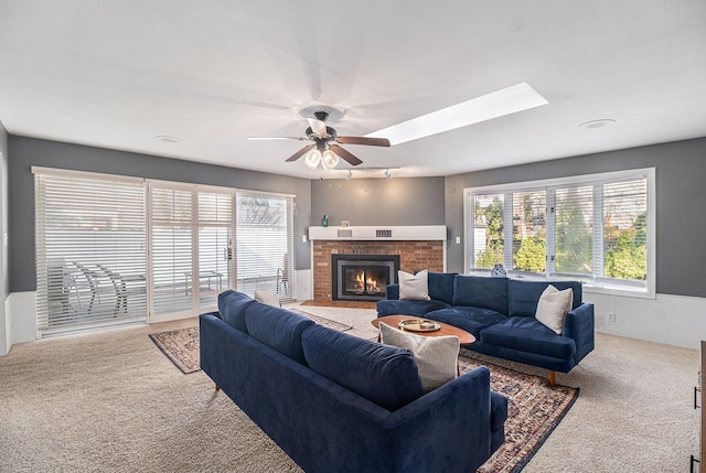 3018 Guilford Dr, Royal Oak, MI 48073 - living room with light colored carpet, a brick fireplace, a ceiling fan, and a skylight