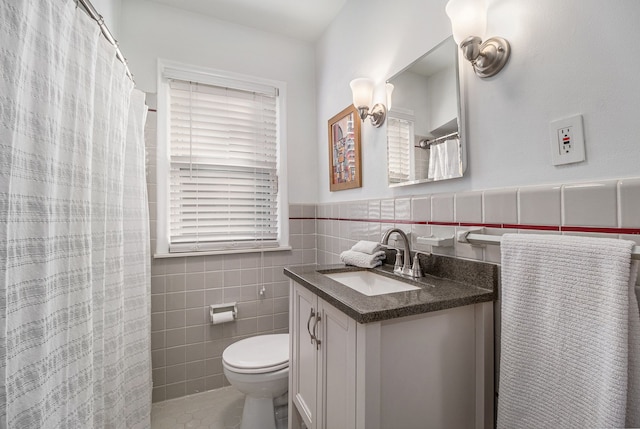 3018 Guilford Dr, Royal Oak, MI 48073 - full bathroom with vanity, tile walls, toilet, a wainscoted wall, and a shower with curtain