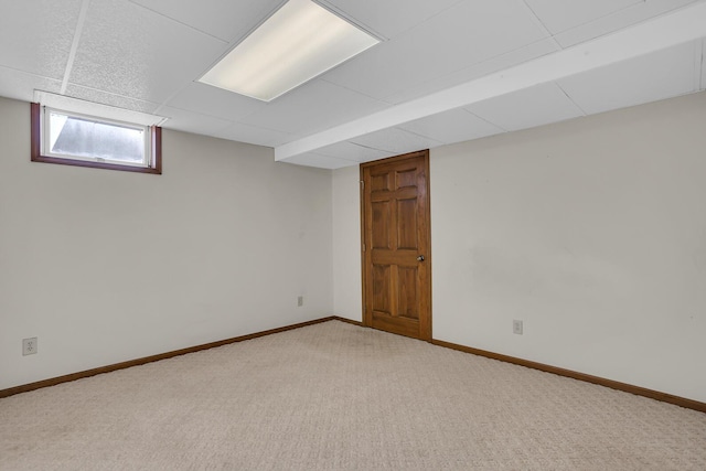 below grade area featuring carpet flooring and baseboards