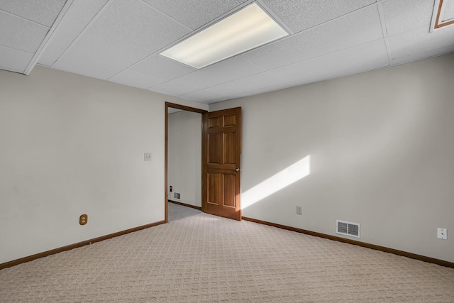 empty room featuring visible vents, baseboards, and carpet floors