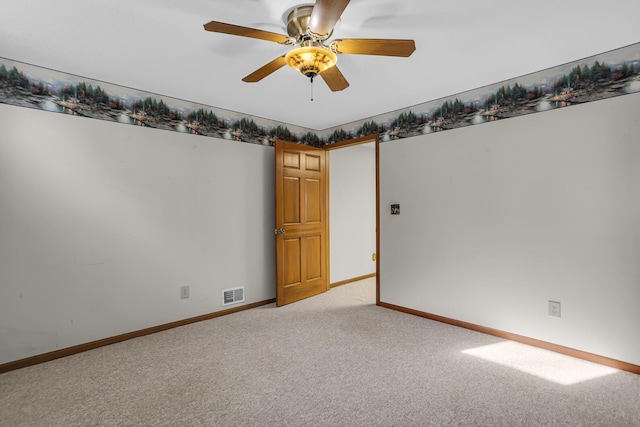 empty room with light carpet, visible vents, baseboards, and ceiling fan