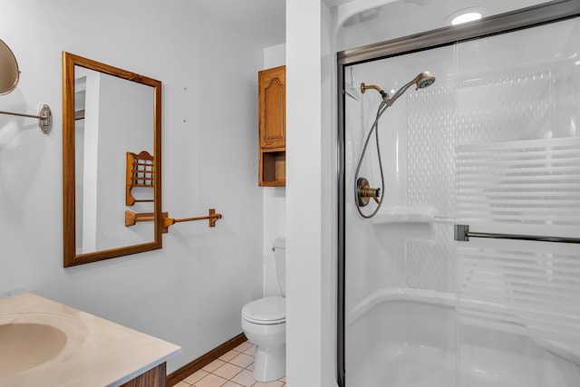 bathroom featuring vanity, baseboards, a shower stall, tile patterned floors, and toilet