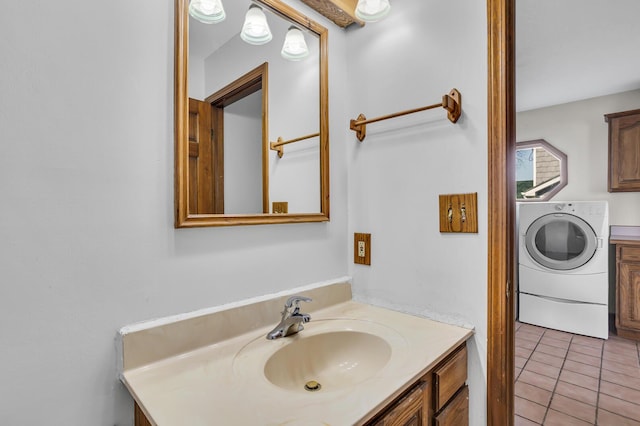 bathroom with vanity, washer / dryer, and tile patterned floors