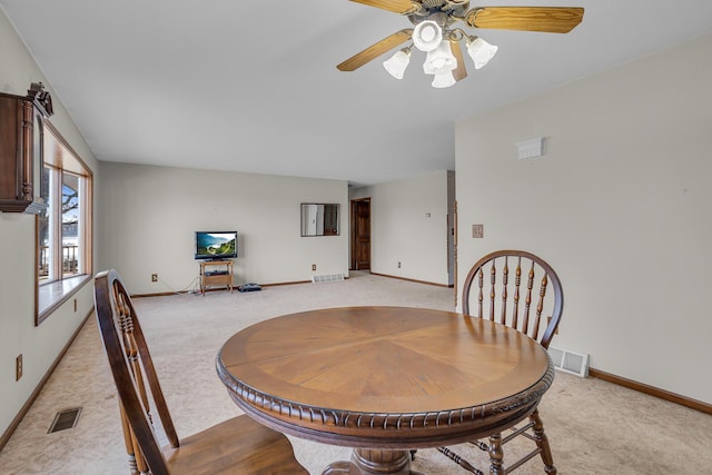 dining area featuring light carpet, visible vents, and baseboards