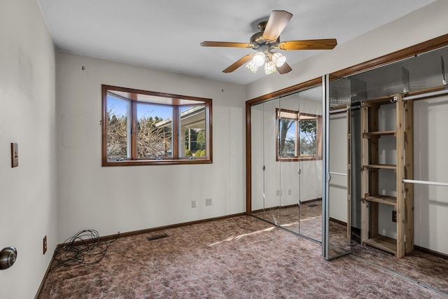 unfurnished bedroom featuring carpet flooring, visible vents, a ceiling fan, and baseboards