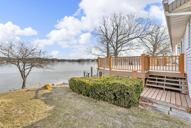 view of yard with a deck with water view