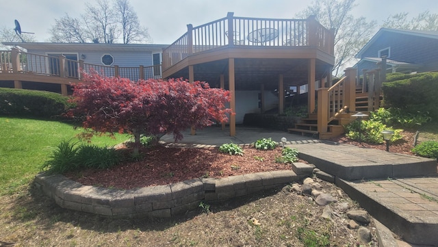 4210 Dawn Dr, Hillsdale, MI 49242 - back of house featuring stairs, a wooden deck, and a patio area