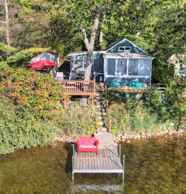 rear view of property with a water view