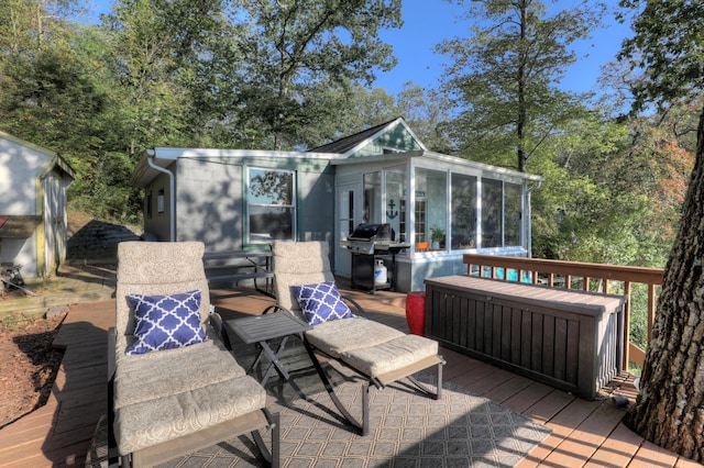 deck with area for grilling and a sunroom