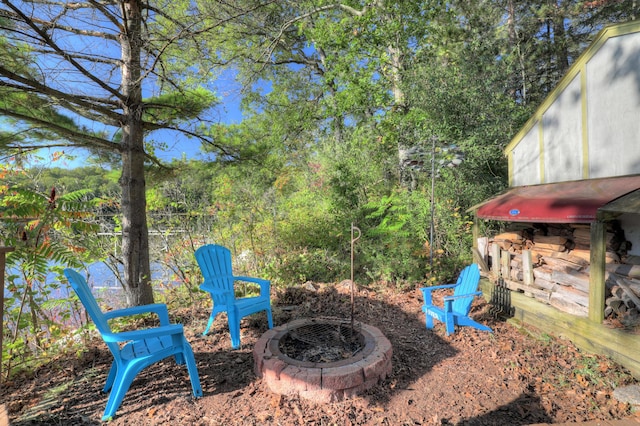 view of yard with an outdoor fire pit