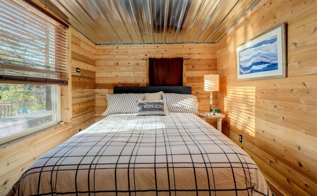 bedroom featuring wood walls and wooden ceiling