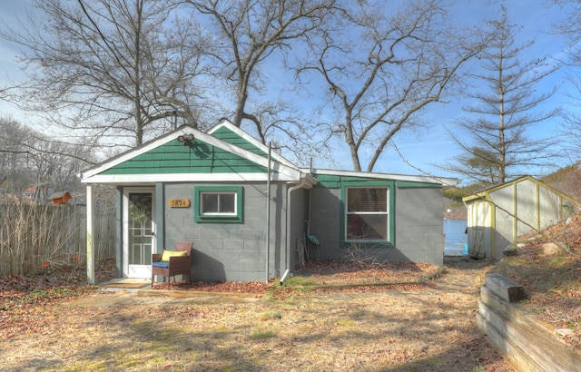 view of outbuilding featuring fence