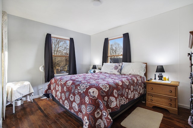 bedroom featuring baseboards and hardwood / wood-style flooring