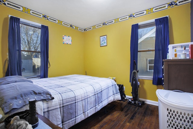 bedroom with hardwood / wood-style floors and baseboards