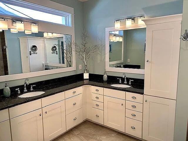 full bathroom featuring double vanity and a sink