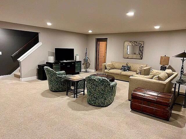 carpeted living area with recessed lighting, stairs, and baseboards