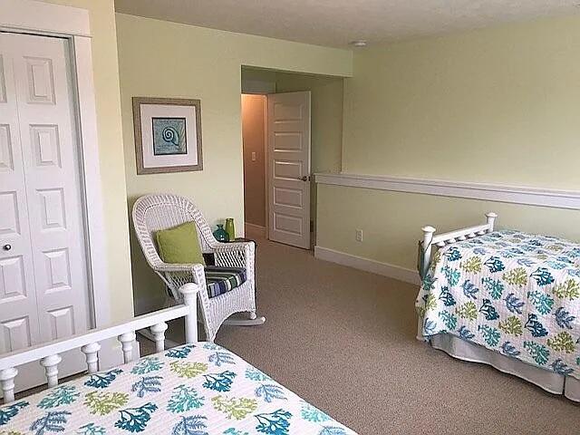 bedroom with baseboards and carpet floors