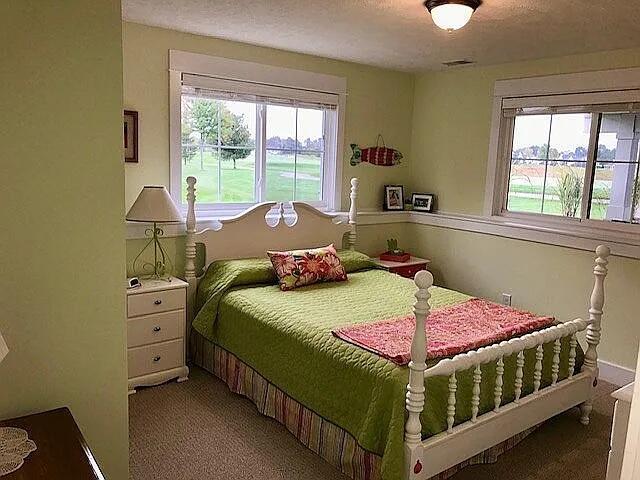 bedroom featuring a textured ceiling and carpet flooring