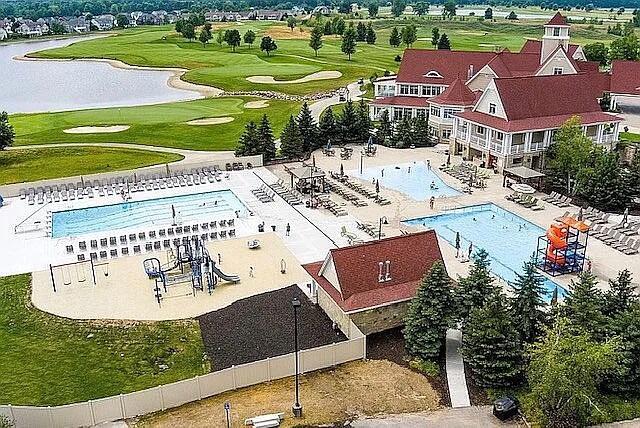 bird's eye view featuring view of golf course and a water view