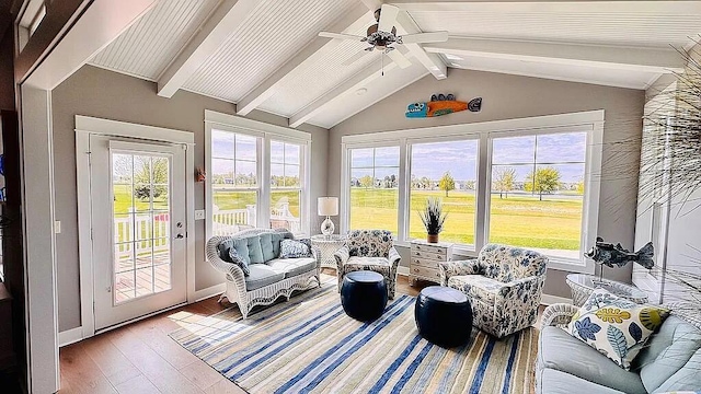 sunroom with vaulted ceiling with beams and a ceiling fan