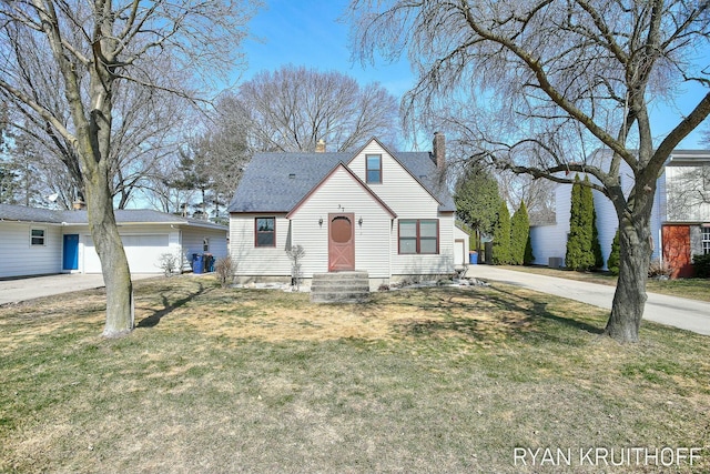 view of front of property featuring driveway, entry steps, a front yard, an attached garage, and a chimney