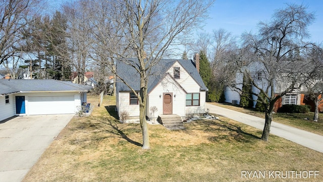 view of front of property featuring concrete driveway, a garage, a front yard, and a chimney