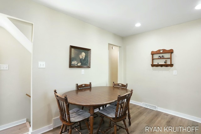 dining room featuring recessed lighting, wood finished floors, visible vents, and baseboards