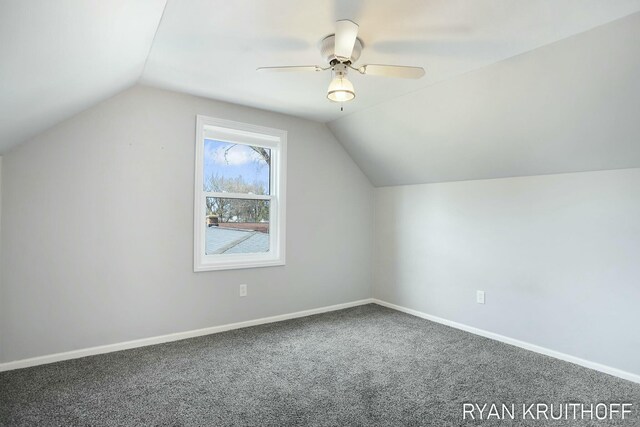 additional living space with a ceiling fan, vaulted ceiling, carpet, and baseboards