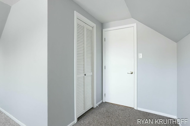 bonus room featuring baseboards, carpet floors, and vaulted ceiling