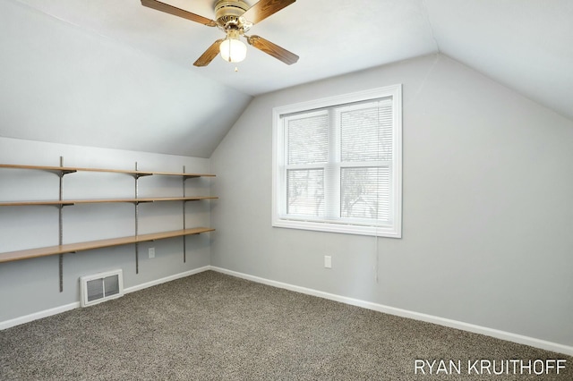 additional living space with visible vents, baseboards, carpet, and vaulted ceiling