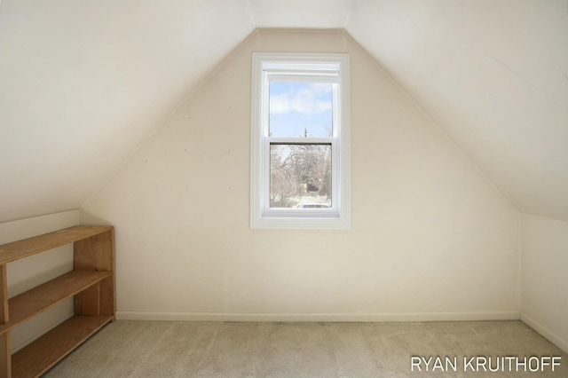 bonus room featuring baseboards, carpet, and vaulted ceiling