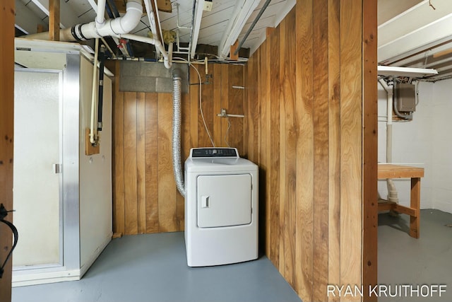 washroom featuring washer / clothes dryer, wood walls, and laundry area