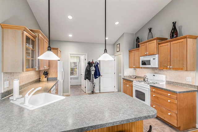 kitchen featuring glass insert cabinets, decorative backsplash, a peninsula, white appliances, and a sink