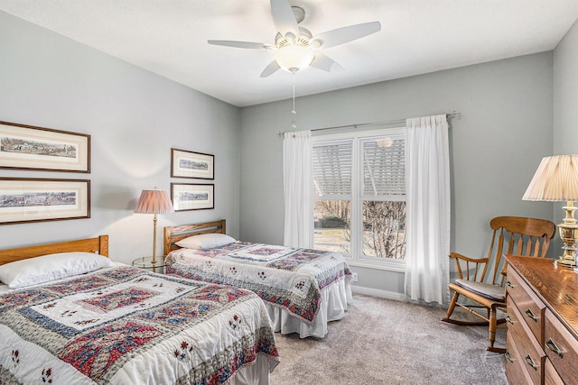 carpeted bedroom featuring baseboards and ceiling fan