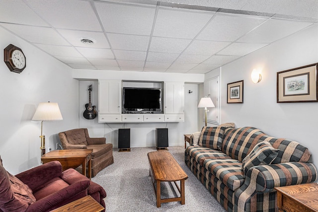 living area featuring visible vents, baseboards, a paneled ceiling, and carpet