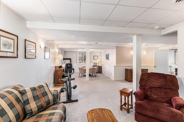 exercise room featuring a drop ceiling, visible vents, carpet flooring, and decorative columns