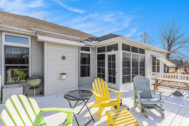 wooden deck with a sunroom