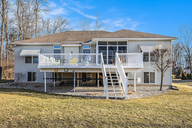 rear view of property featuring stairs, a deck, a yard, and a shingled roof