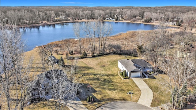 birds eye view of property with a forest view and a water view