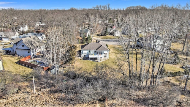 birds eye view of property featuring a wooded view