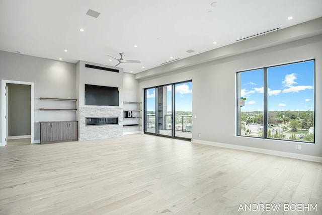 unfurnished living room featuring recessed lighting, a healthy amount of sunlight, light wood-style floors, and ceiling fan