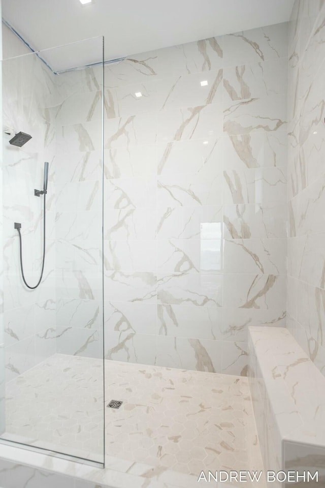 full bathroom with a marble finish shower