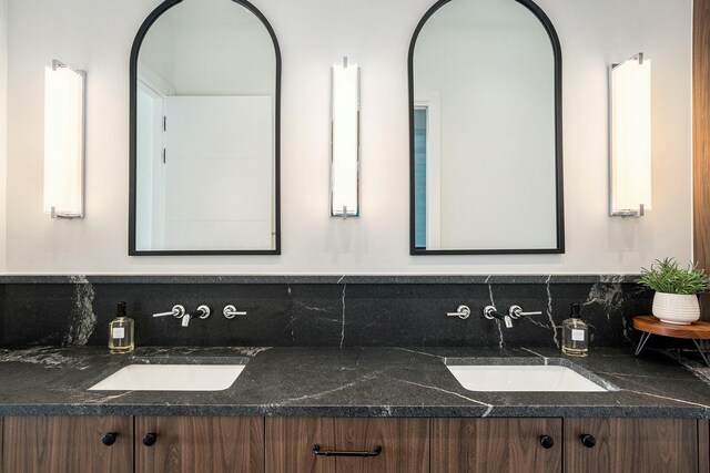 bathroom with decorative backsplash and vanity