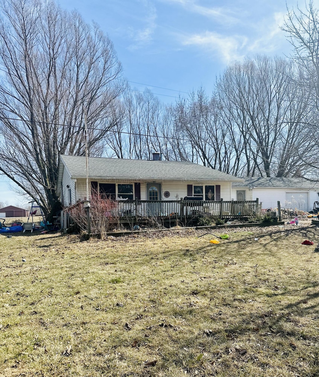 single story home featuring a deck and a front yard