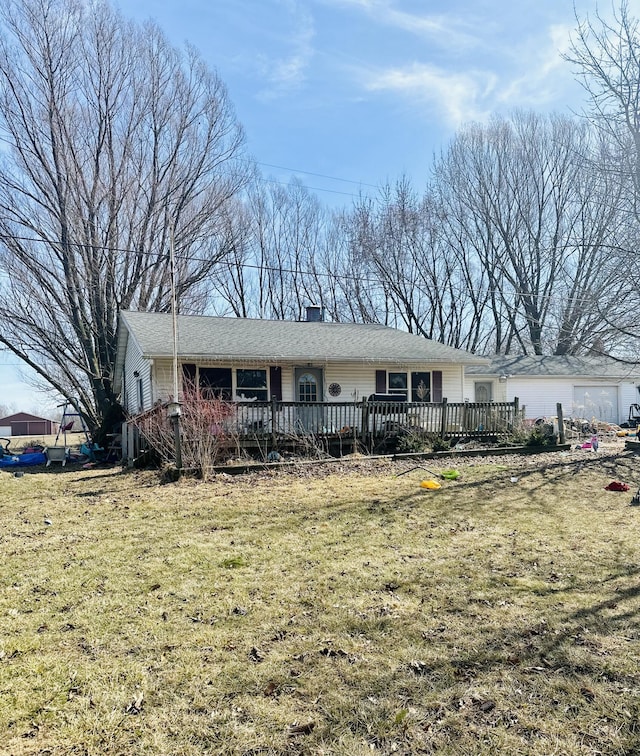 single story home featuring a deck and a front yard