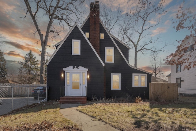 view of front of property featuring a chimney and fence