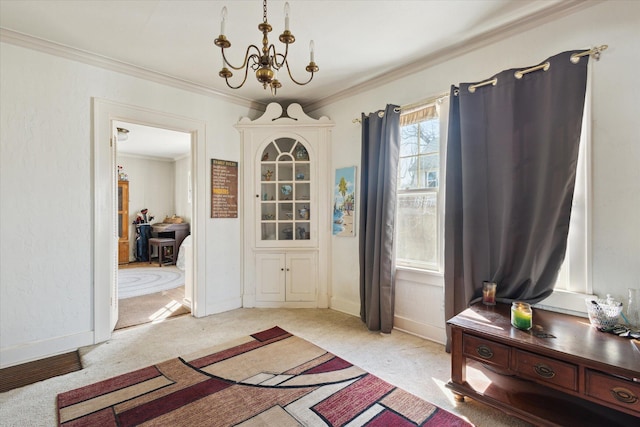 entrance foyer featuring a notable chandelier, baseboards, light colored carpet, and crown molding