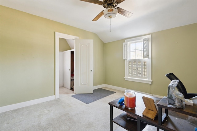 interior space with lofted ceiling, baseboards, and ceiling fan