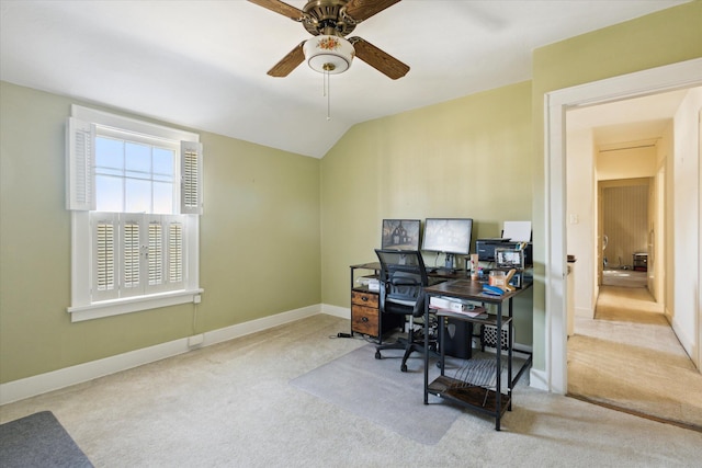 home office featuring carpet flooring, baseboards, a ceiling fan, and vaulted ceiling